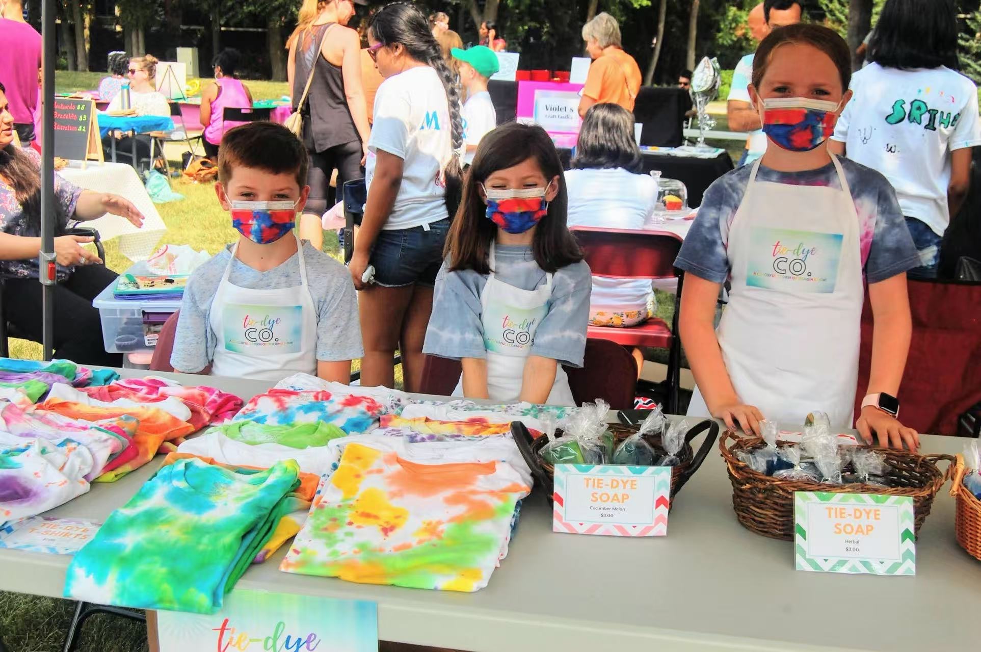 Kidpreneurs sharing products with fair visitors
